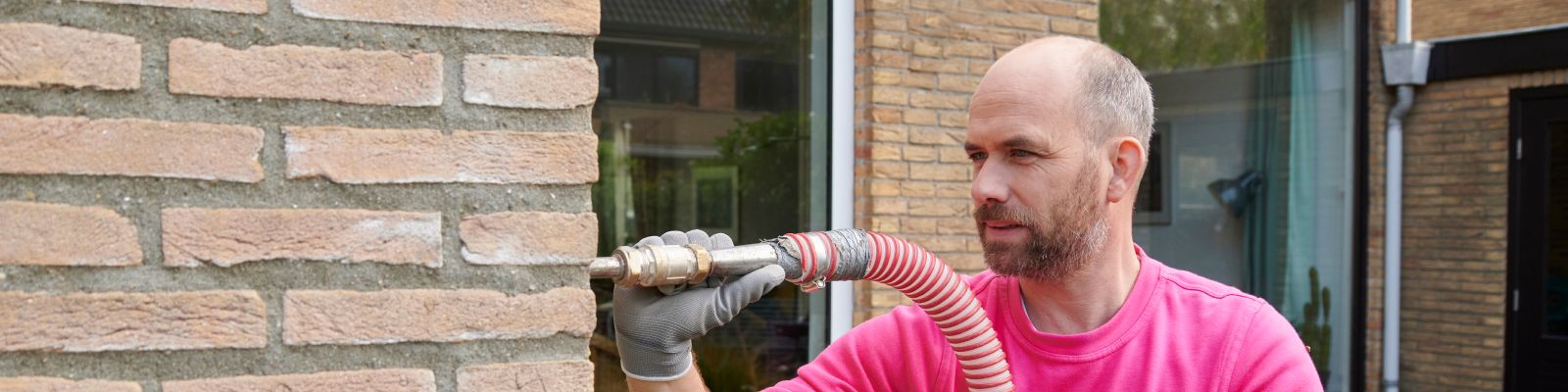 man is bezig met spouwmuur