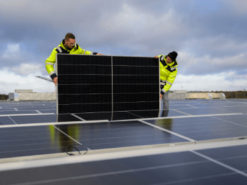 Mannen die zonnepanelen plaatsen op dak